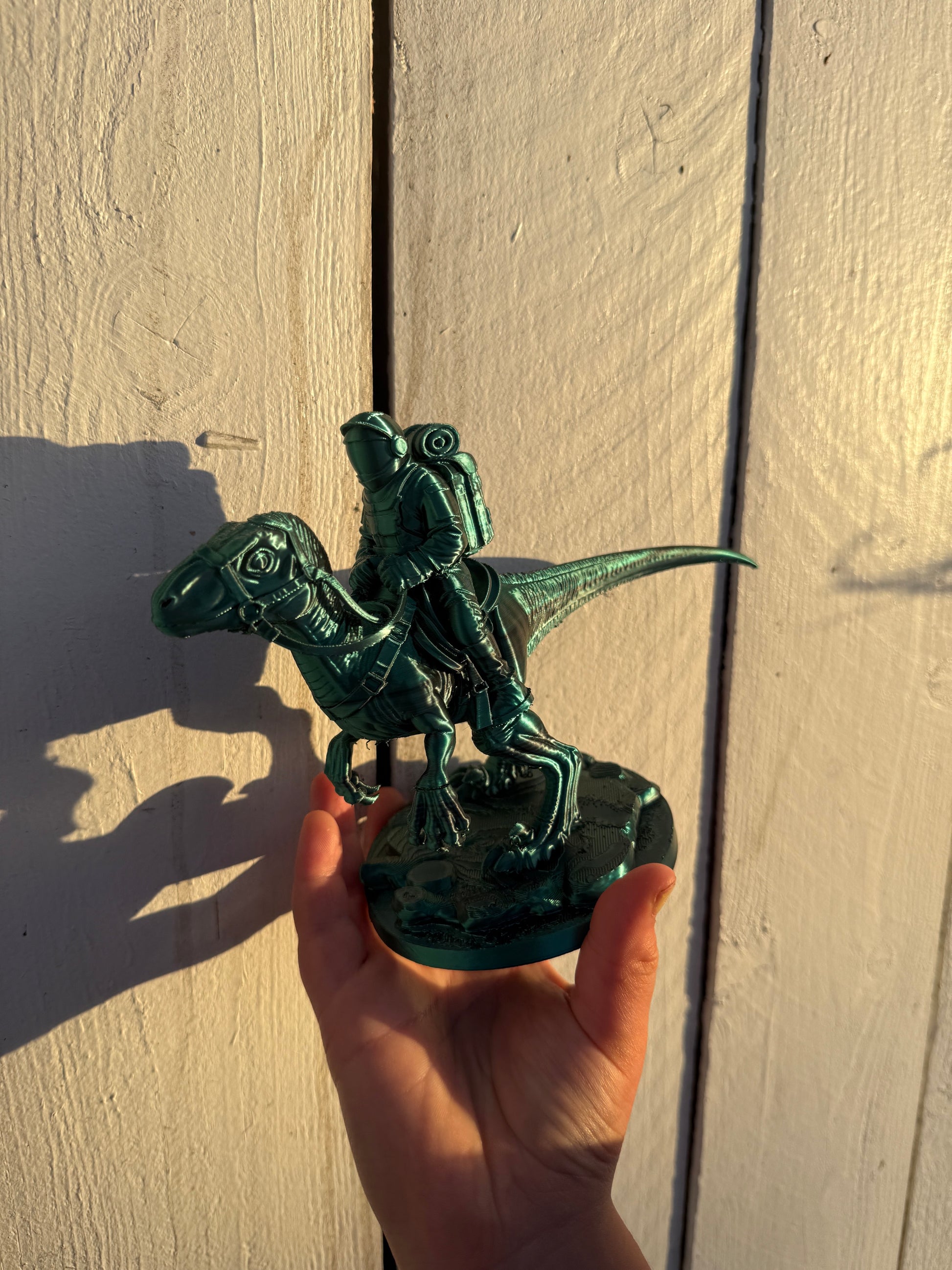 Green 3D printed dinosaur rider statue made by Nora front view