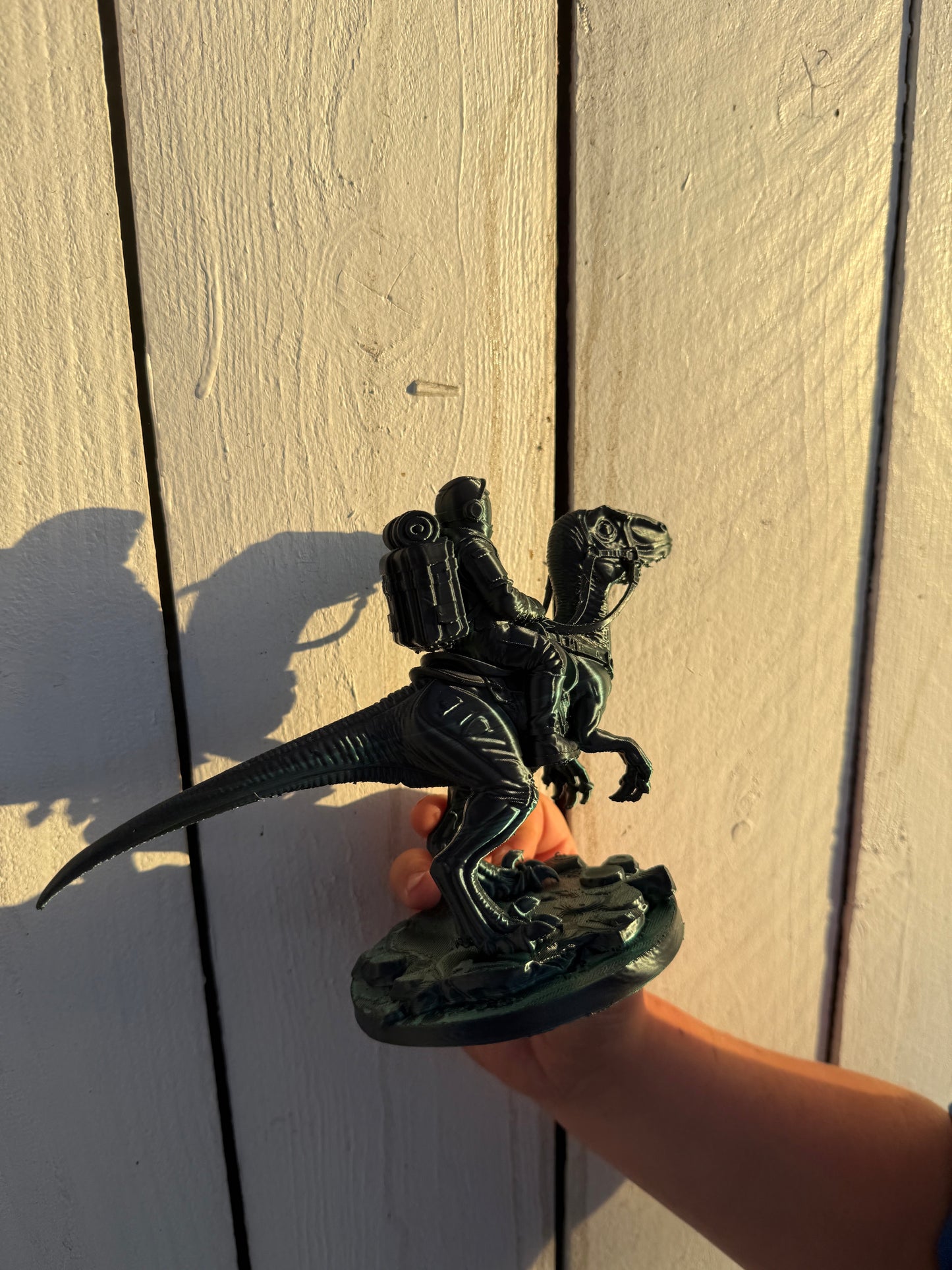 Green 3D printed dinosaur rider statue made by Nora side view