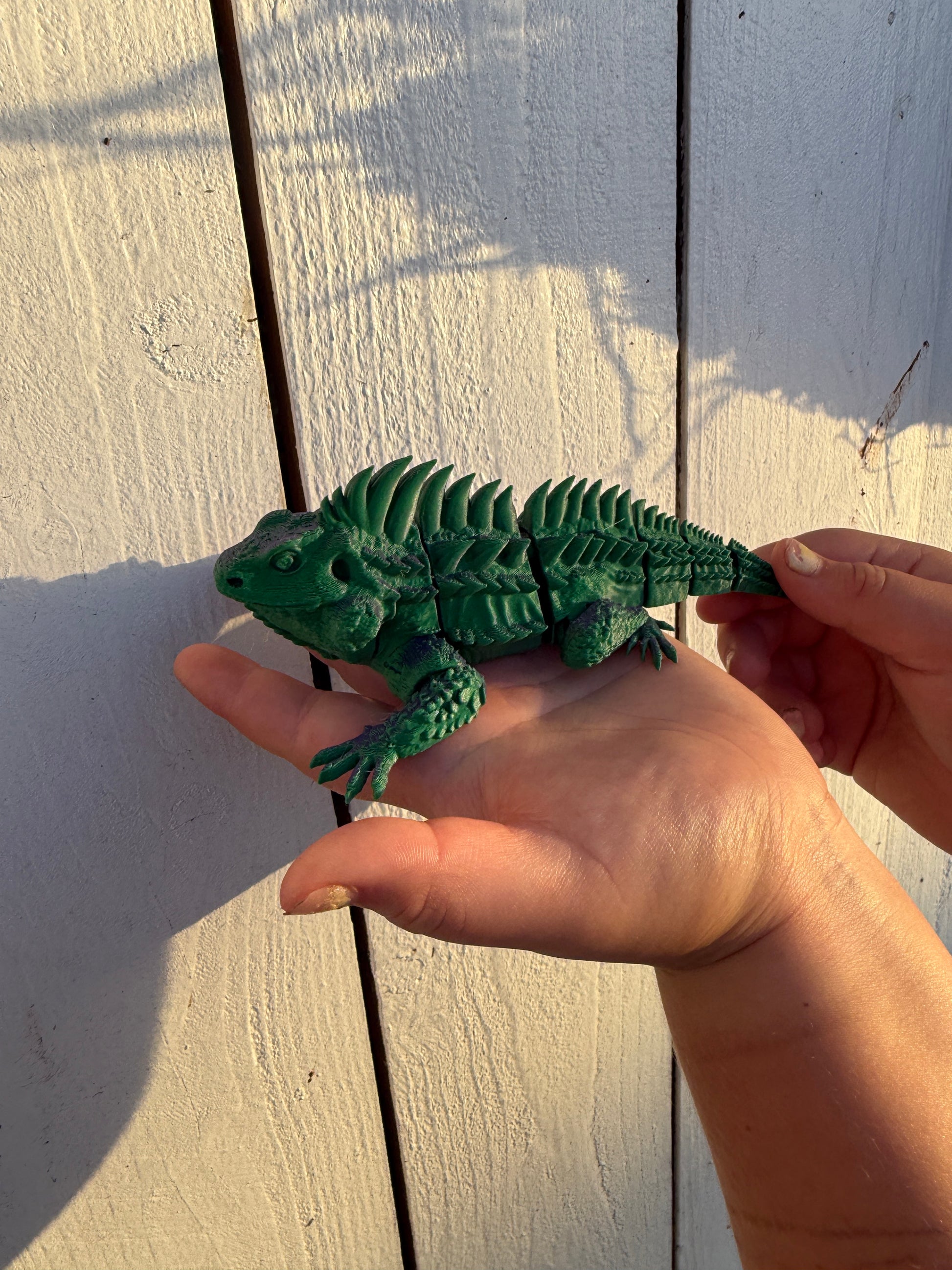 Side view of green articulated chameleon 3D print